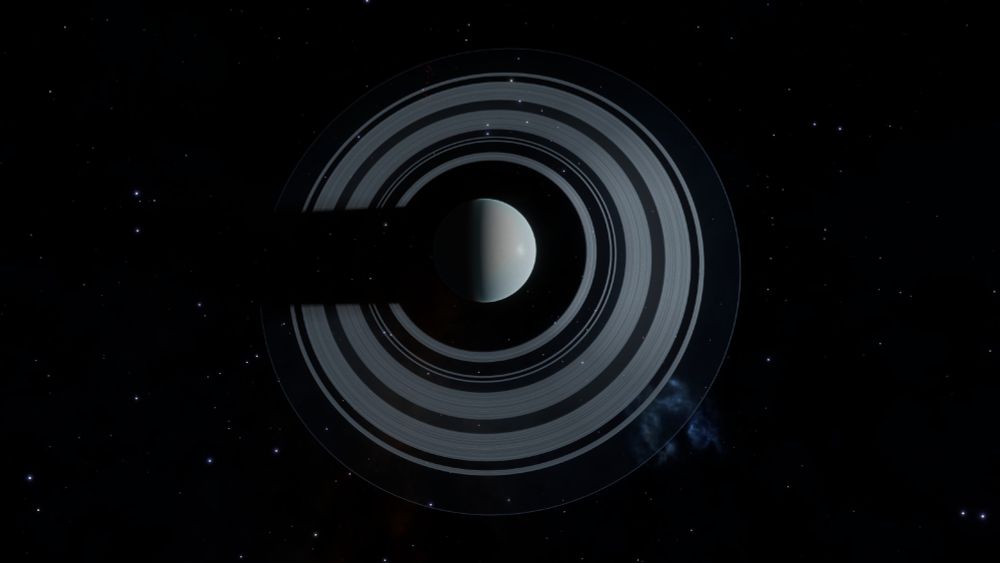 Large grey and white ice world with a large grey and black ring.