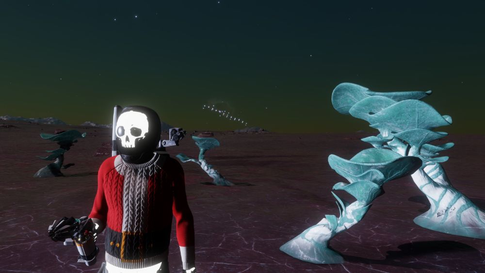 A dude in a glowing skeleton space suit and Santa sweater. 