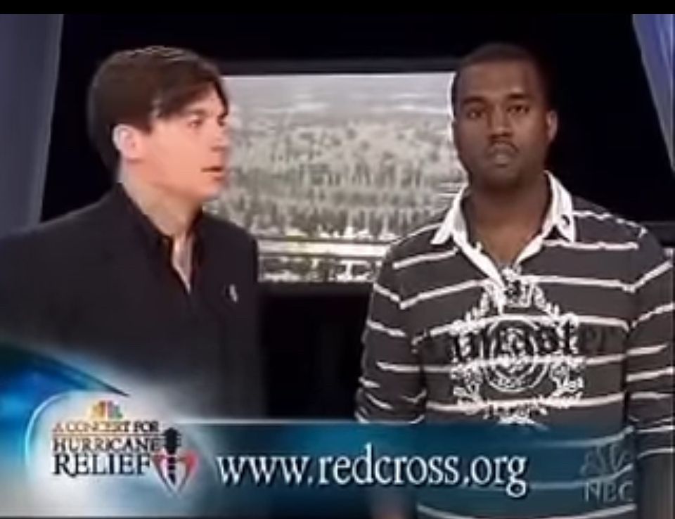 Mike Myers standing next to Kanye West during the hurricane Katrina relief telethon in 2005 when Kanye famously said “George Bush doesn’t care about Black people.” Myers looks shocked by the statement.