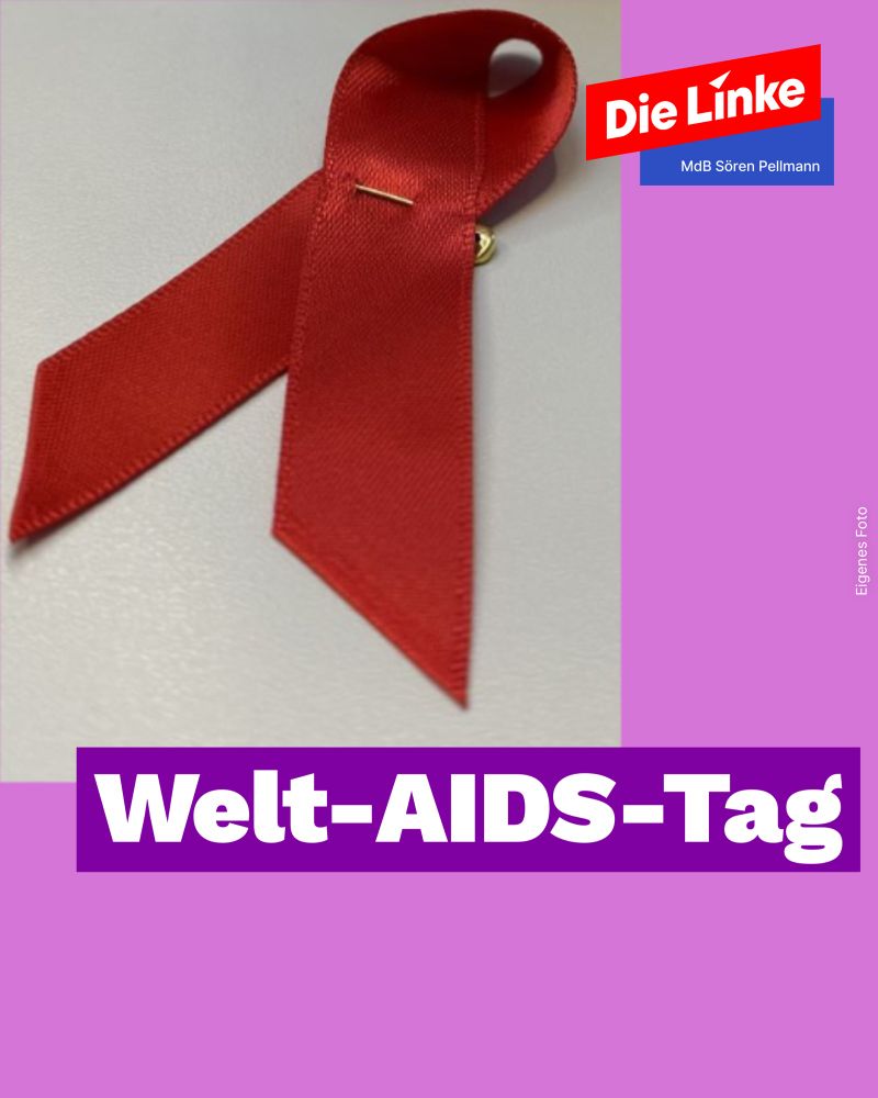 Eine rote Schleife. Mit Aufdruck: Welt-AIDS-Tag 