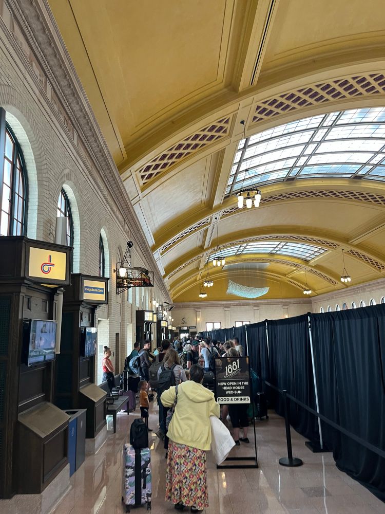 A long group of people wait in line to get on the Borealis at Union Depot