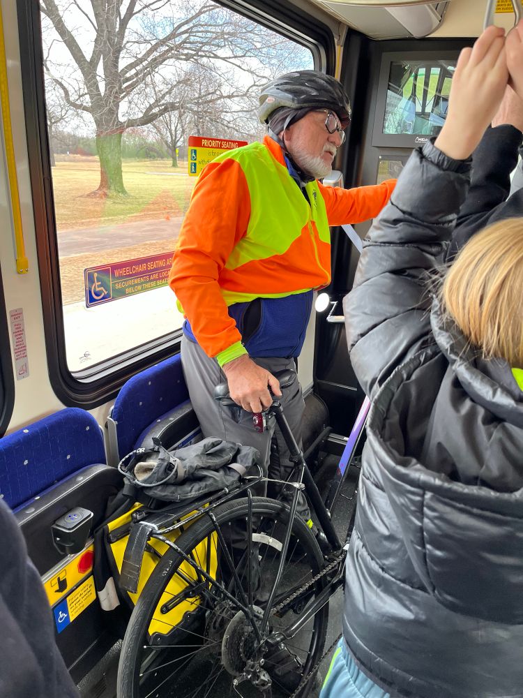 Person with bike stands onboard a Metro Transit bus