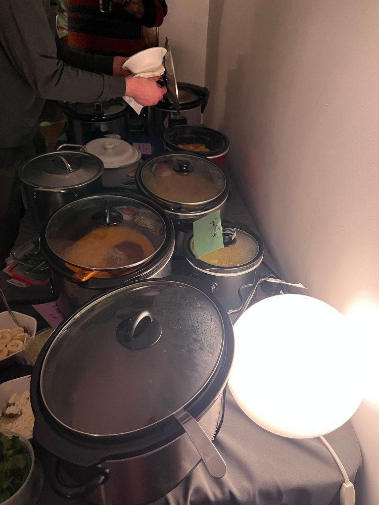 Endless crockpot of soups on a table 