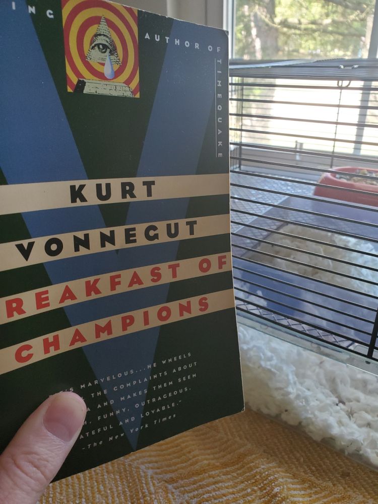 Cover of Breakfast of Champions by Kurt Vonnegut with a cute little hamster in the background.
