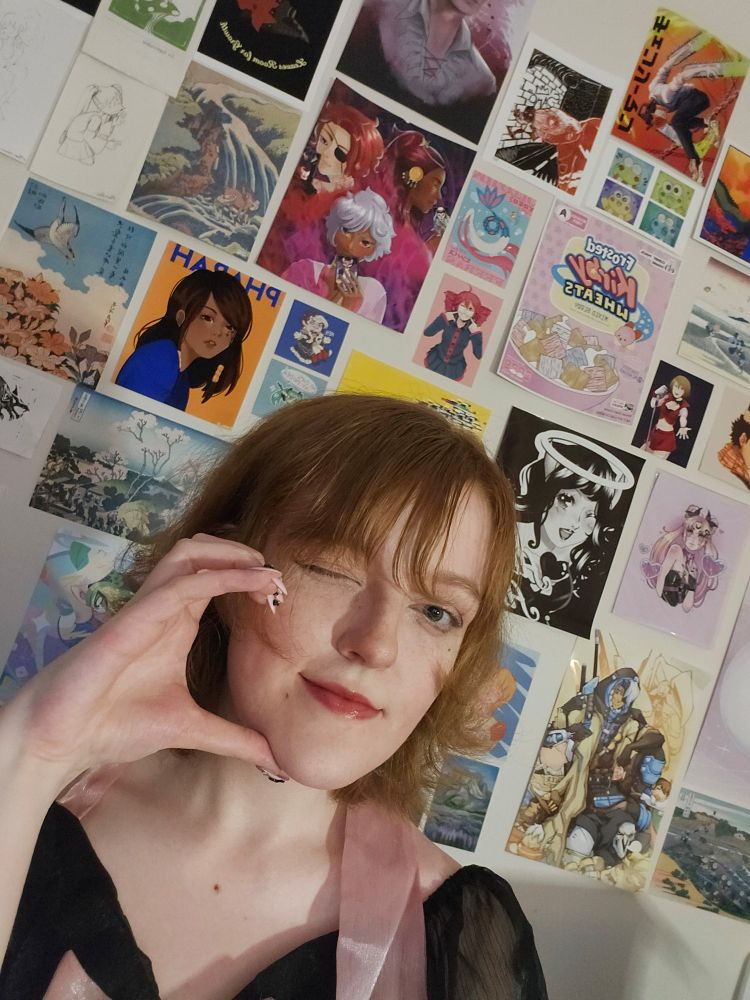 Same person and background, different pose. Here she is winking with her hand cupped around her cheeks like a half-heart shape.