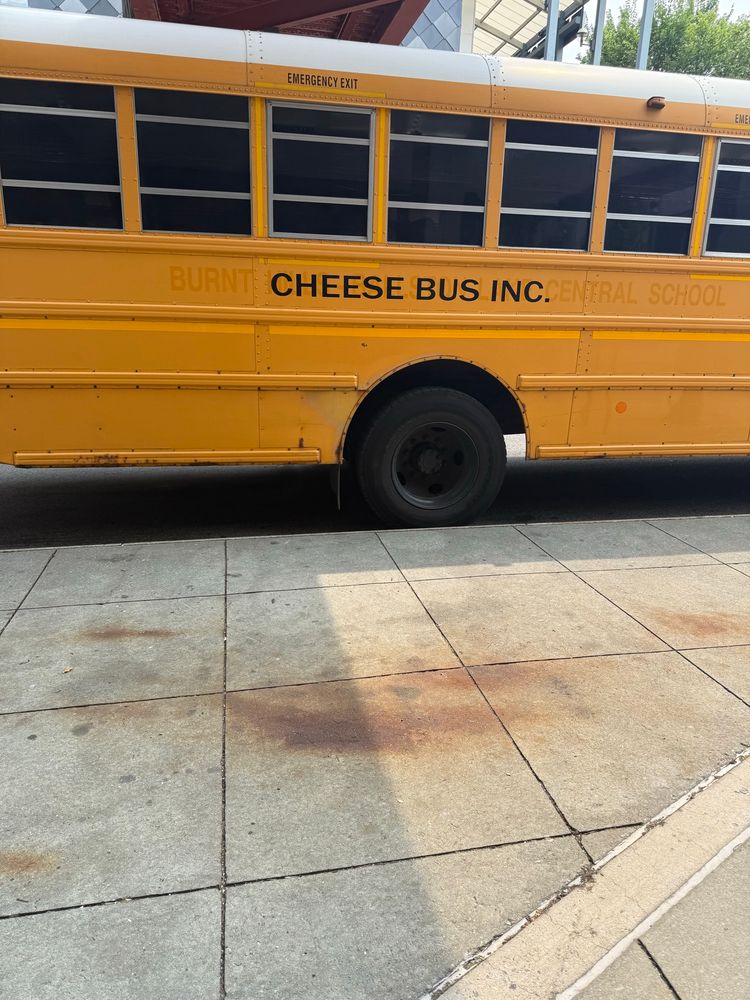 A yellow school bus with the text “burnt cheese bus Inc.” in black