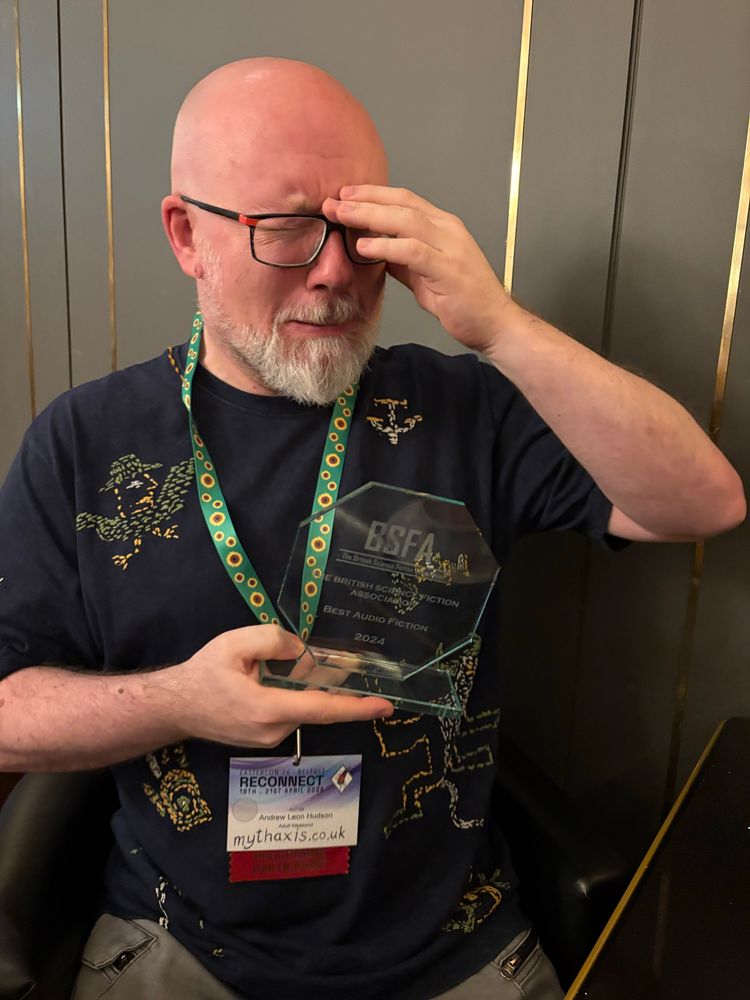 Andrew Leon HUDSON poses with the BSFA for Best Audio Fiction.