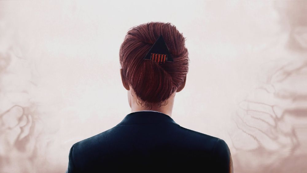 A virtual photograph from Control. Jesse Faden is seen from the back, wearing a smart suit with her hair in a tight bun.