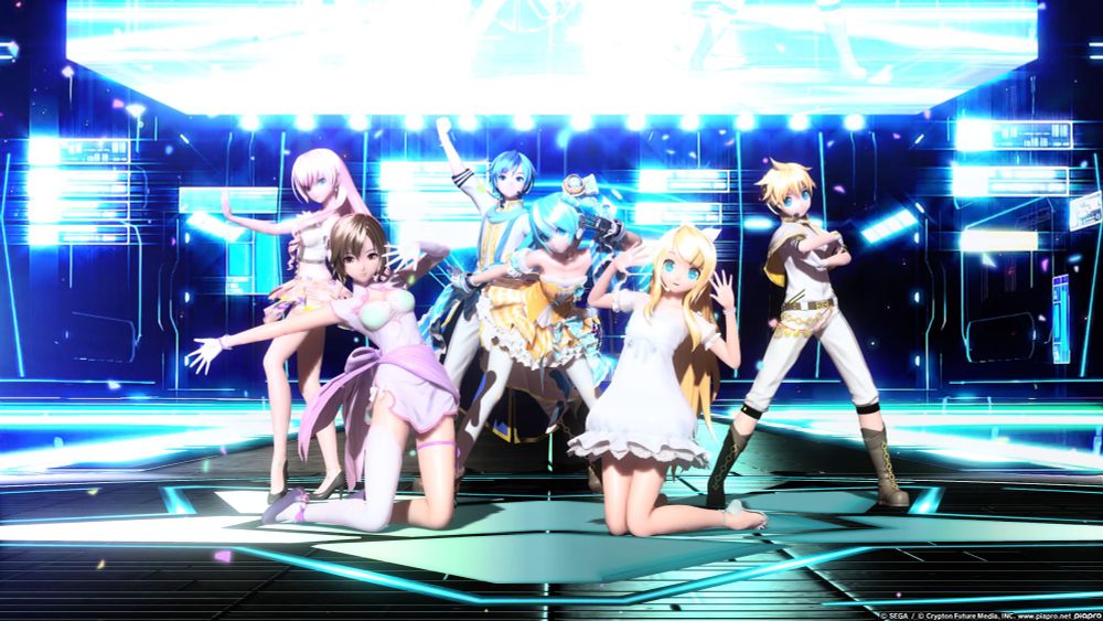 a picture taken from project diva. luka, meiko, kaito, miku, rin and len are all posing on a stage with many screens glowing bright blue behind them. there are also blue lights on the stage floor! colourful confetti is falling around them! 