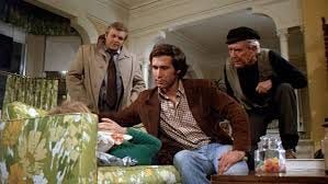Chevy Chase, Brian Dennehy and Burgess Meredith in a scene from 1978 movie Foul Play.