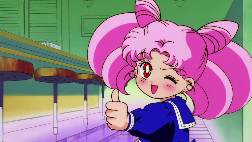 Screenshot from the Sailor Moon R movie of Chibiusa giving a thumbs up and winking.