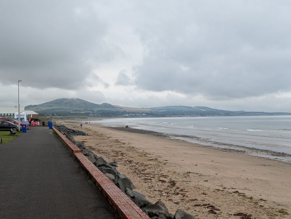 A view of the sandy beach at Leven with some hills in the distance 