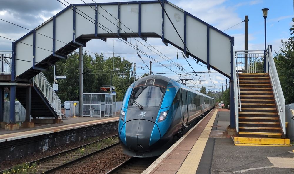 A Class 802 train passing through Slateford train station 