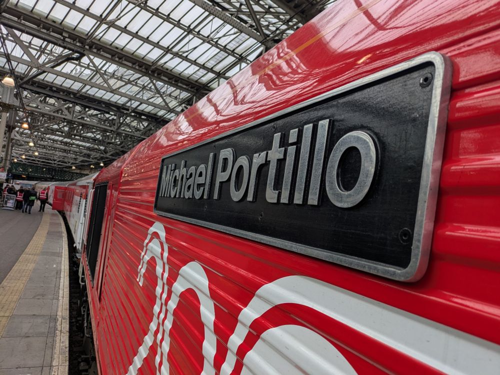 A black nameplate with "Micheal Portillo" engraved in silver 