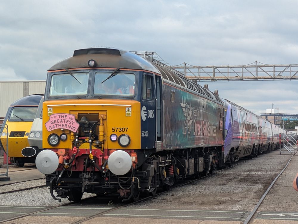 A Class 57 train hauling a Pride Coloured Pendolino train into a siding in Derby Litchurch Lane