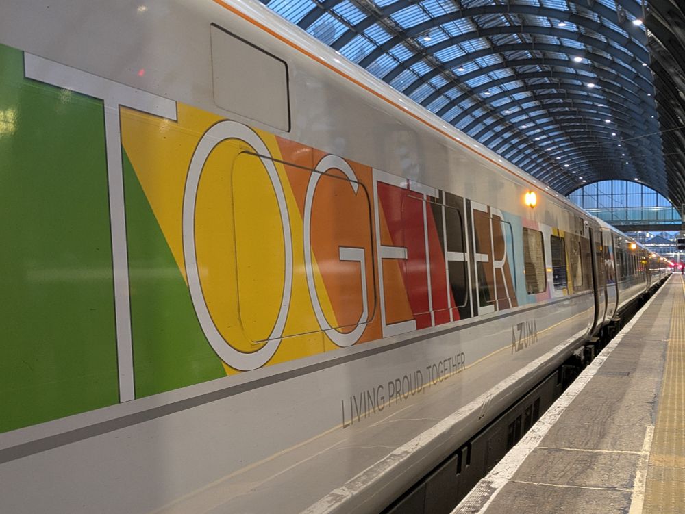 The name "Together" with a pride flag on the side of an Azuma train at London King's Cross 
