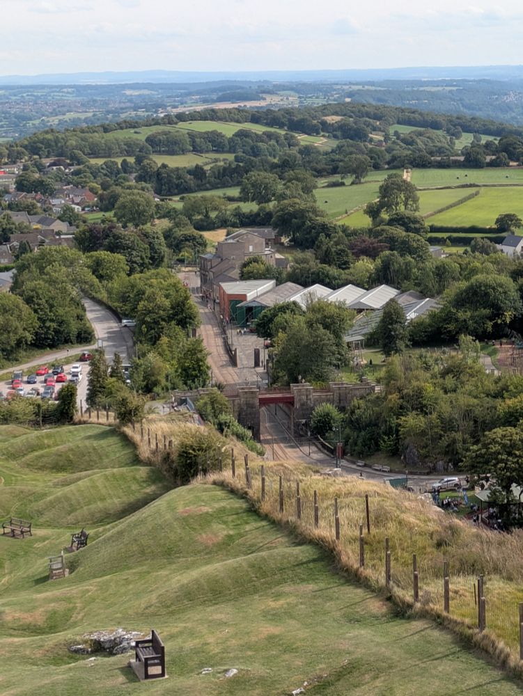 A view of green hills and some tram tracks running down the hill