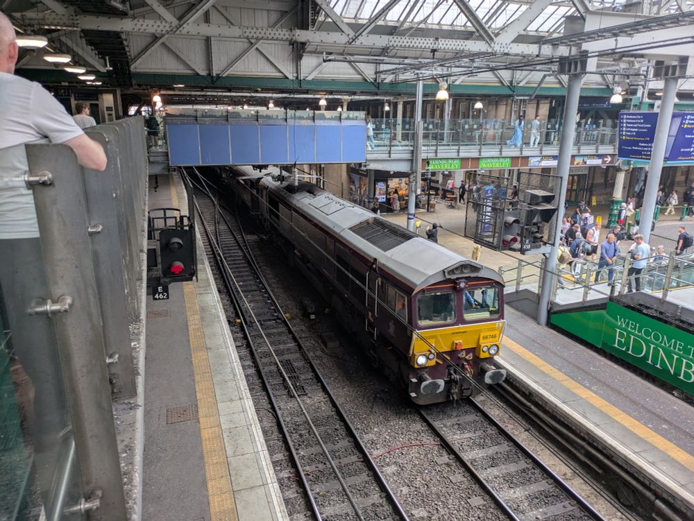 The Royal Scotsman Train passing under a foot bridge at Edinburgh Waverley train station 