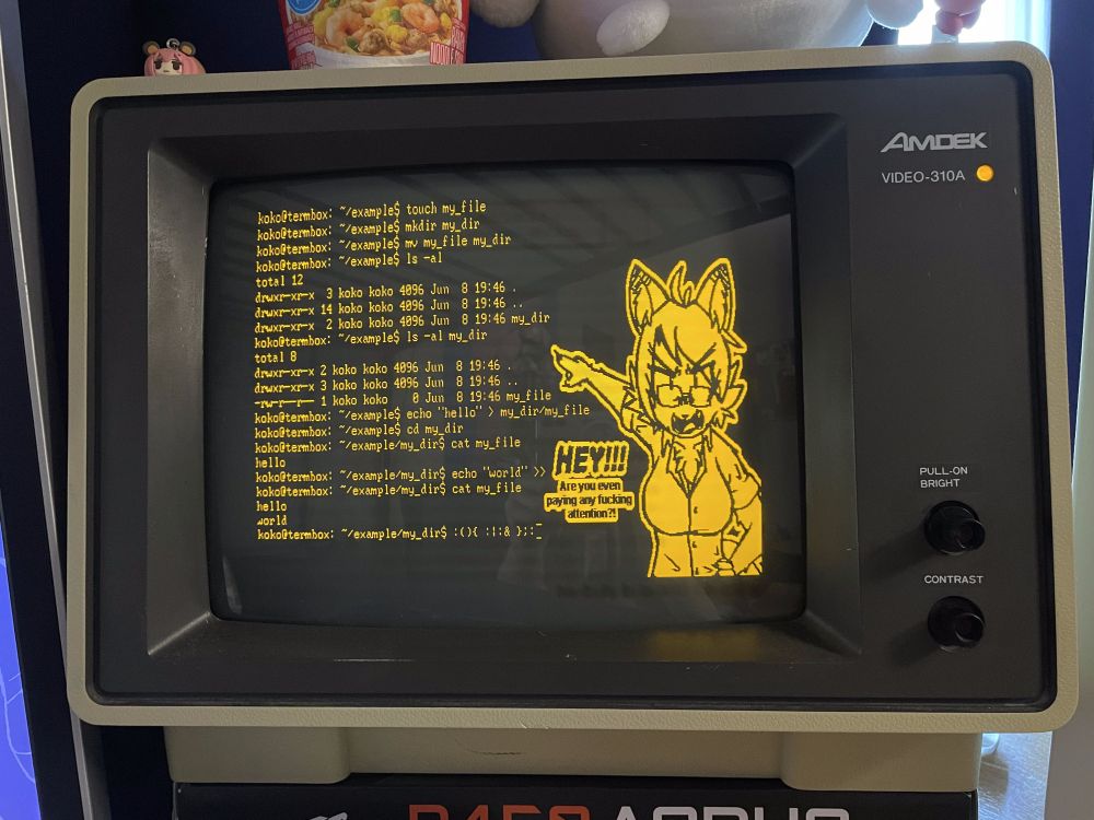 an amber monochrome monitor displaying some example commands (touch, mkdir, cd, echo, cat) in use. beside them is a sketch of my fursona, angrily looking at the viewer, shouting 'HEY!!! Are you even paying any fucking attention?!'