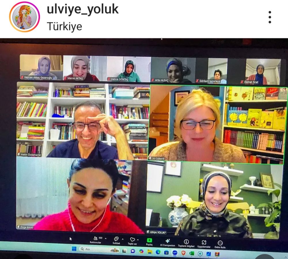 Computer screen showing zoom call in progress. Multiple faces of Turkish members plus Jo, a white woman in her 40s. Everyone is smiling.