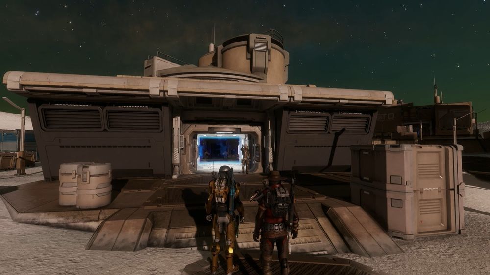 Two unhelpful CMDRs watch on as the 'volunteer' enters the dark power centre in Elite Dangerous. What could possibly go wrong?