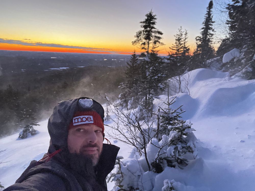 A dumbass on the side of a snow covered mountain 