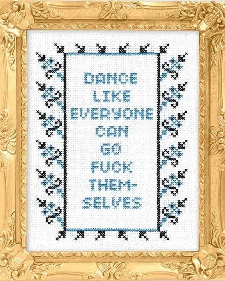 Cross stitch. Blue stitching on a white background surrounded by a gold frame. Reads dance like everyone can go fuck themselves 