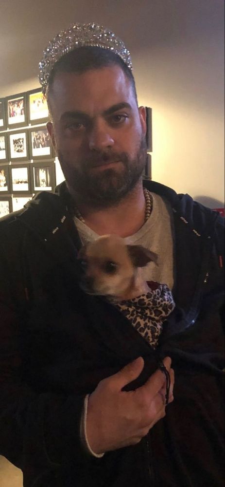Eddie Kingston wearing a tiara and holding a chihuahua 