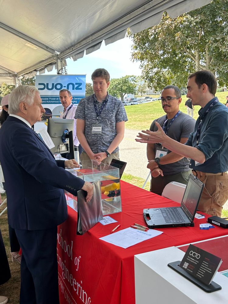 U.S. Senator Jack Reed speaks with Nils Tack, Thales Costa Silva, and Peter Gunnarson, from the Wilhelmus Lab at Brown University School of Engineering.