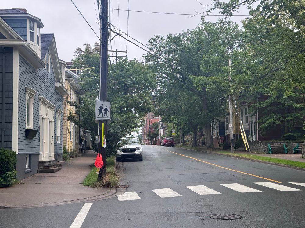 A mostly empty Morris street in Halifax, with a parked car