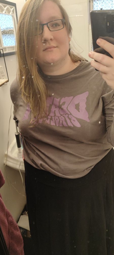 Mirror selfie of me in a black skirt and long sleeve Death By Roll Up tshirt