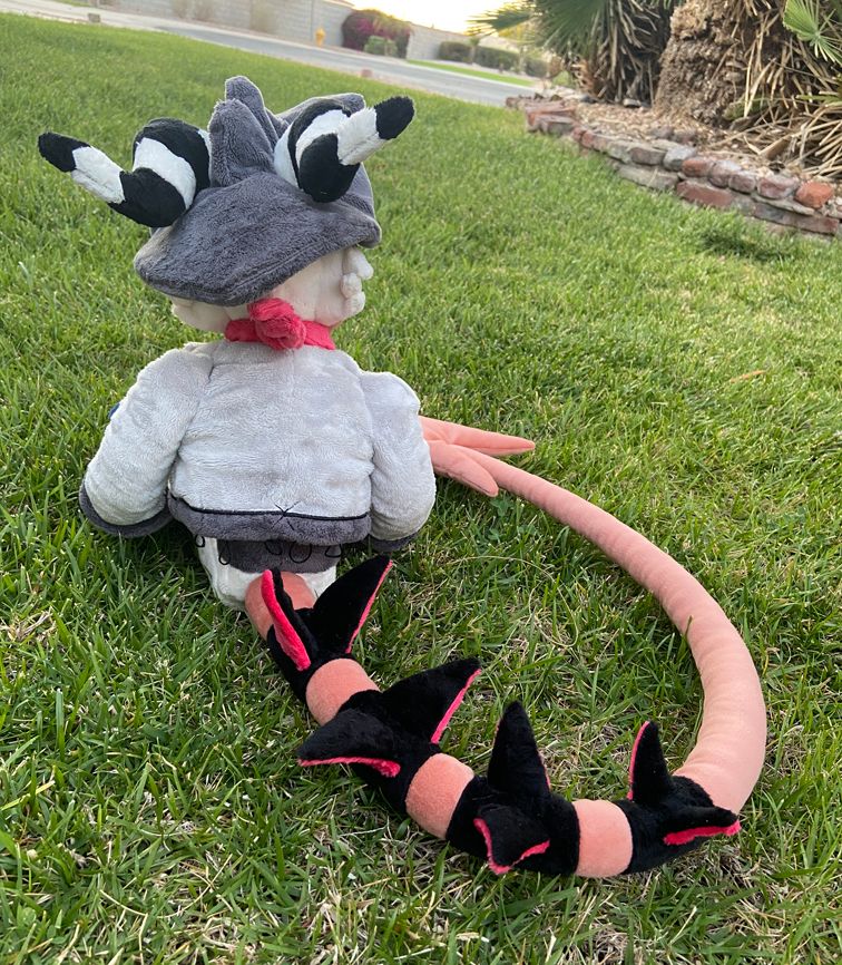 Striker plush sitting down from behind