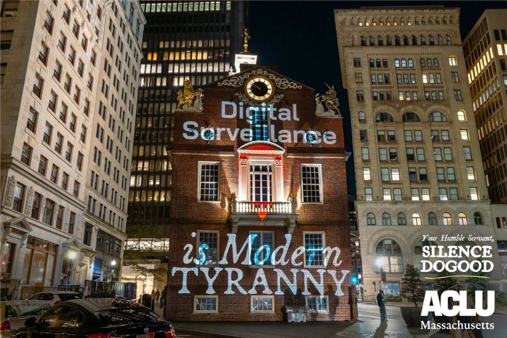 Silence DoGood projection on the Old State House reading "Digital Surveillance is Modern TYRANNY"