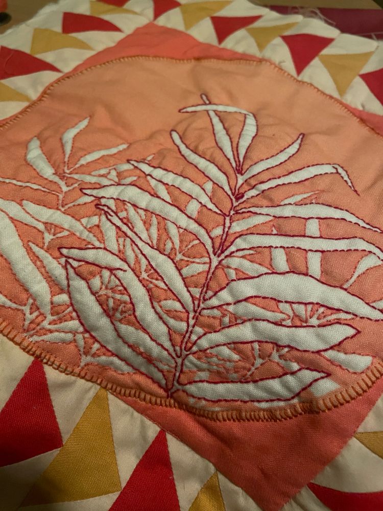 Closeup on a quilted panel illustration of plant fronds