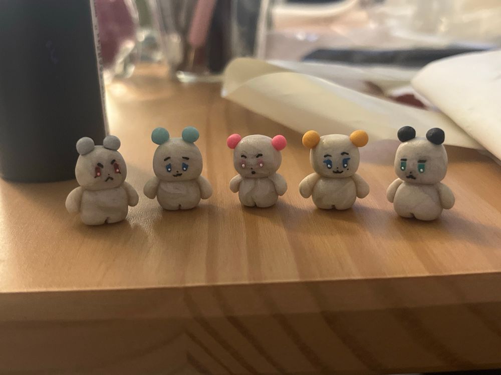 Half inch clay sculptures of kpop group Plave's mascots, MMMM. From left to right, Muhmo, Meymu, Miimu, Moi, and Meowmi.