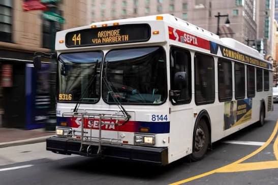 A white SEPTA municipal bus with blue and red accent colors