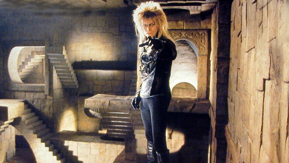 David Bowie, pointing at us. In the background you see the stairs from the endscene in the movie labyrinth. The stairs go in all directions like the paintings from esscher. 