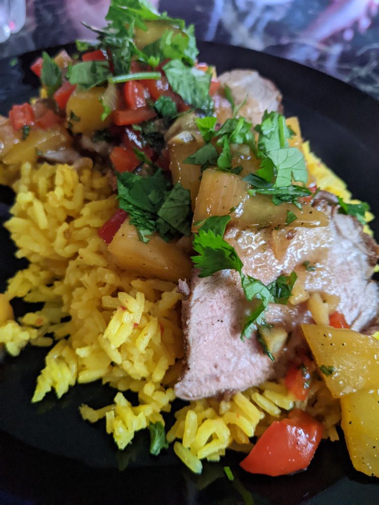 Jamaican pork loin with spicy mango salsa and saffron rice