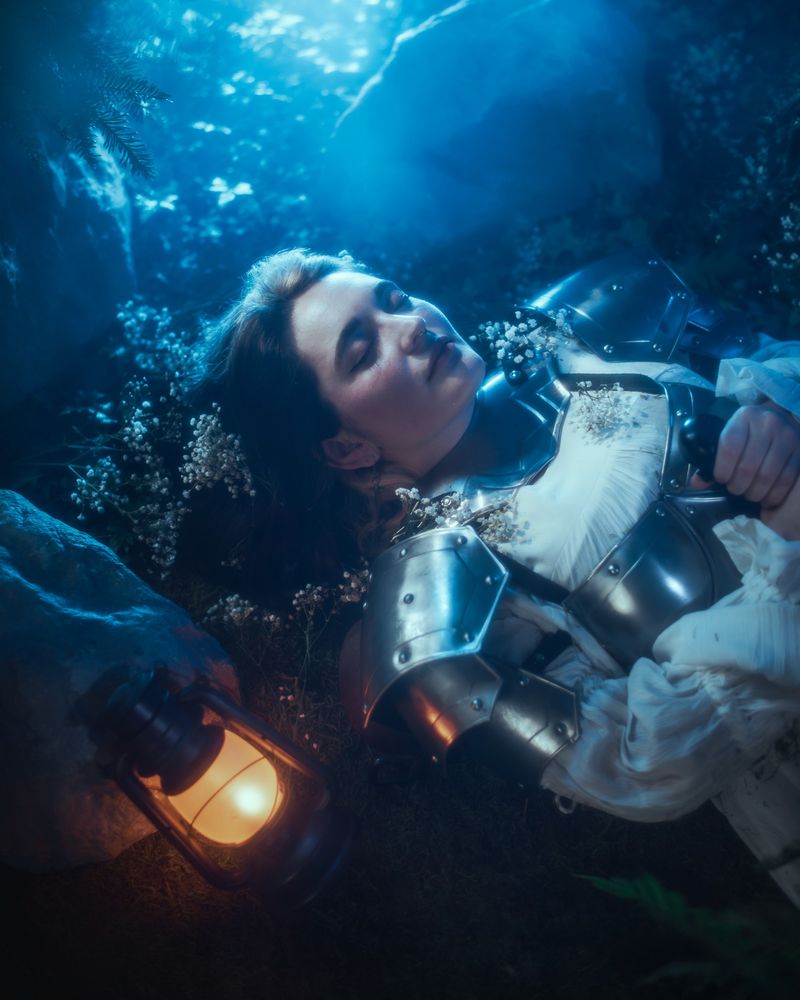 Girl in white dress and armor holding a sword with a lantern