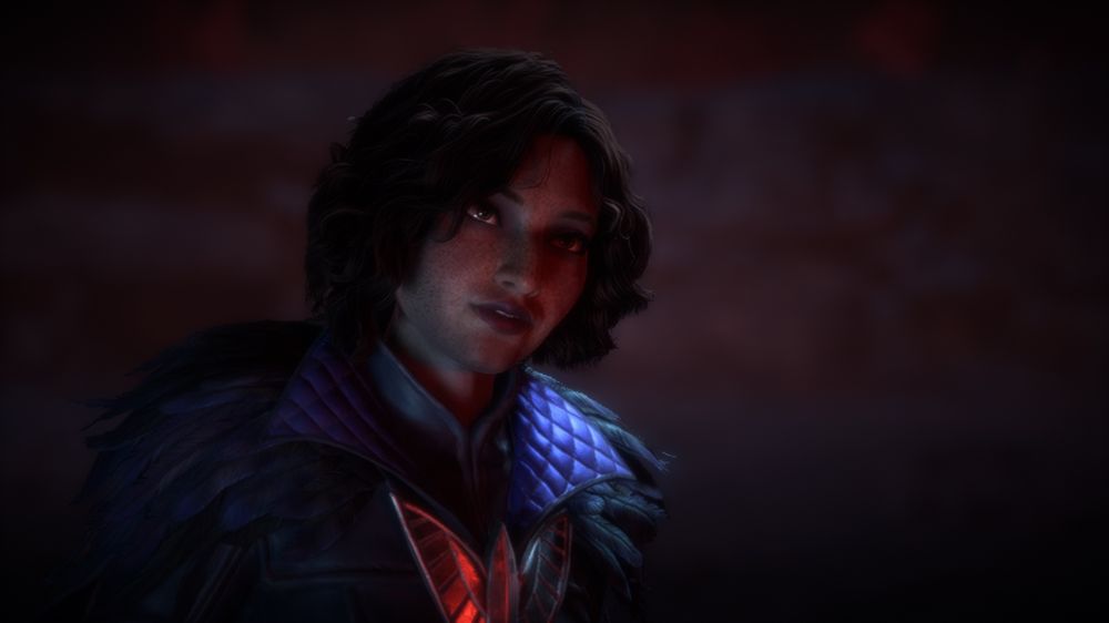 Josette “Rook” De Riva with short curly brown hair and freckles in crows armor in red lighting.