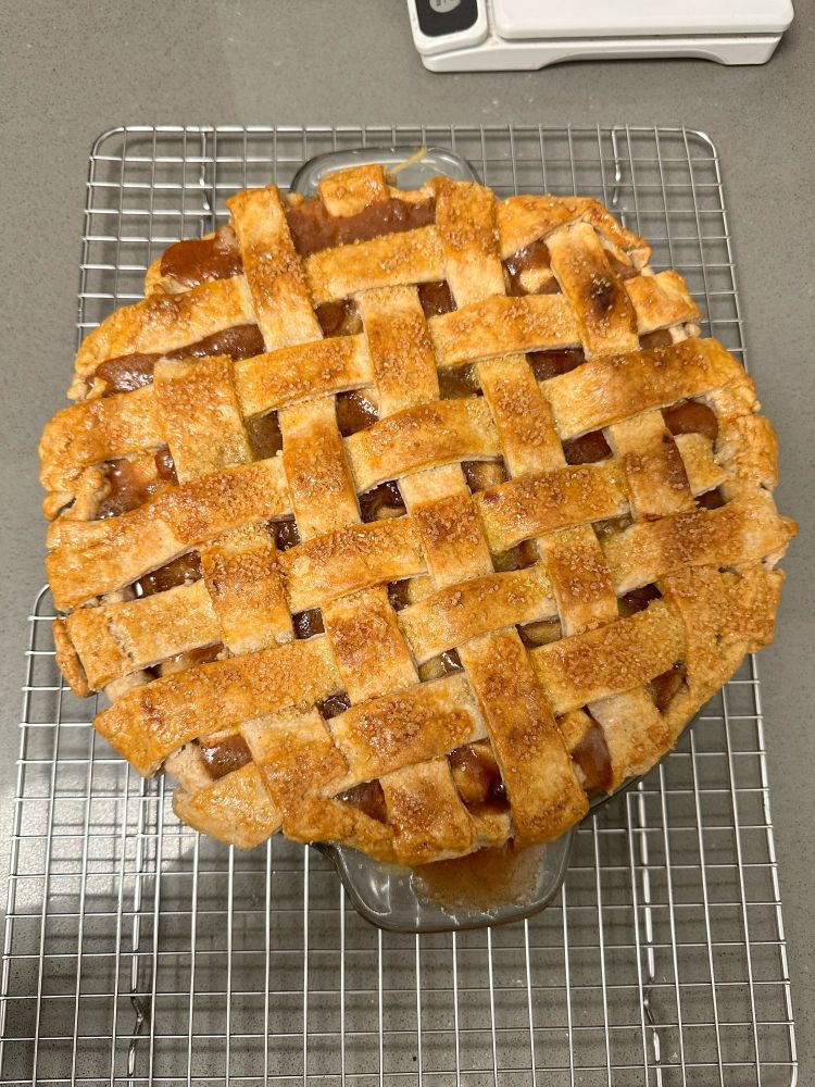 A baked apple pie with latticed crust on top