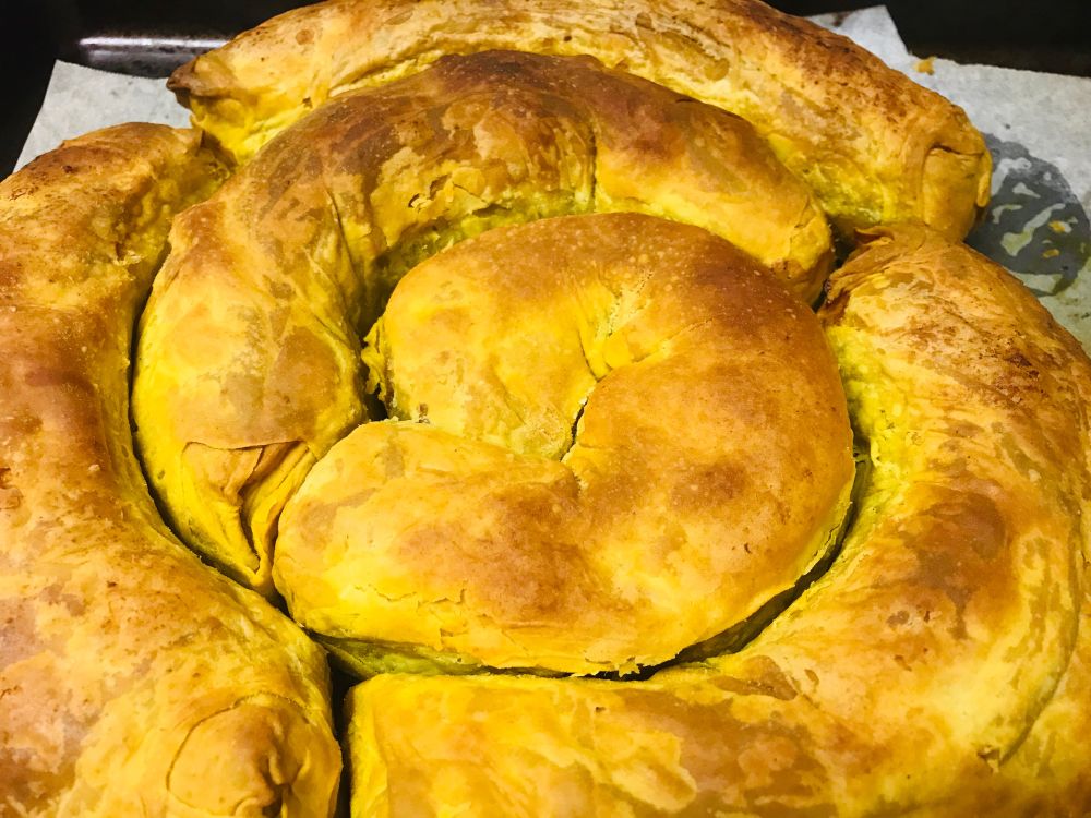 A spiral of baked golden phyllo pastry, seen from above
