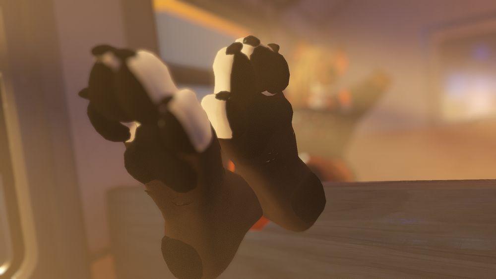 vrchat photo:
phox relaxing on a metro seat, both paws kicked up and crossed on the back of the seat in front of him. one set of toes scrunched in.