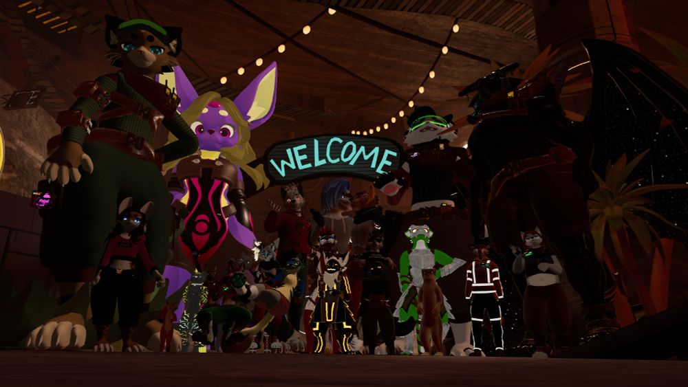 vrchat screenshot taken at Furality Umbra. a group photo of myself (hidden among the smaller folks) and too many wonderful people to name, who all made the experience unforgettable.