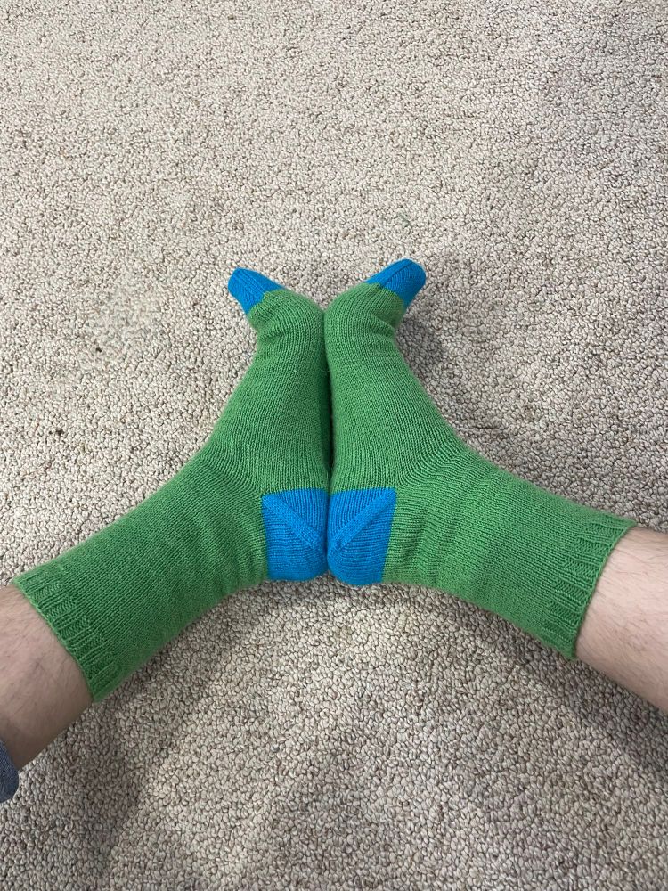 A cute pair of grass green socks with turquoise heels and toes. Please excuse the leg hair, I don’t shave during the winter.