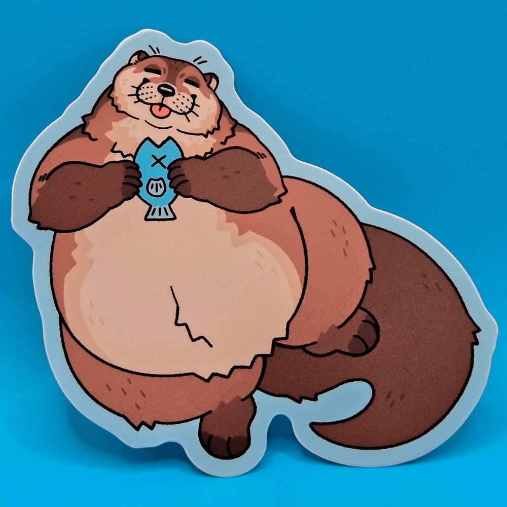 A matte vinyl sticker, the design is an otter holding a fish