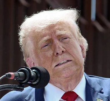 A photo of the tangerine Mussolini, looking particularly bad.