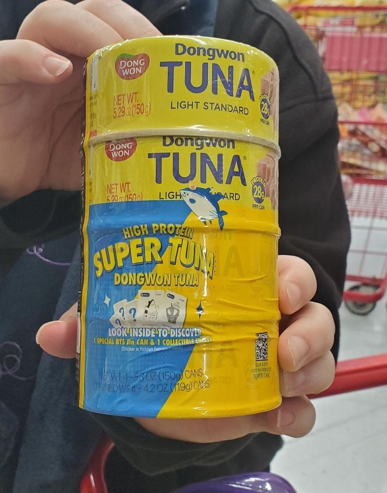 Picture of a stack of four of the Dongwon Tuna "Super Tuna" cans with Jin