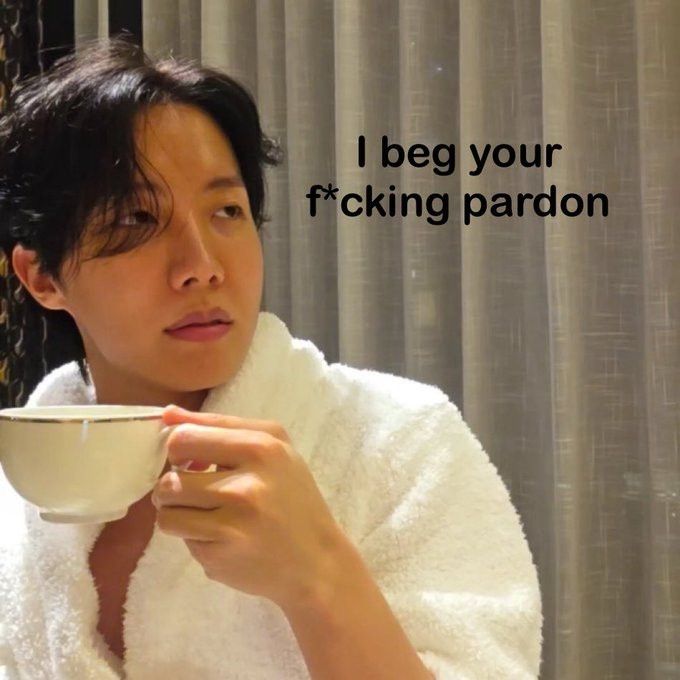 JHope in a robe, drinking tea, staring with diagust to the side captioned, "I beg your fucking pardon"