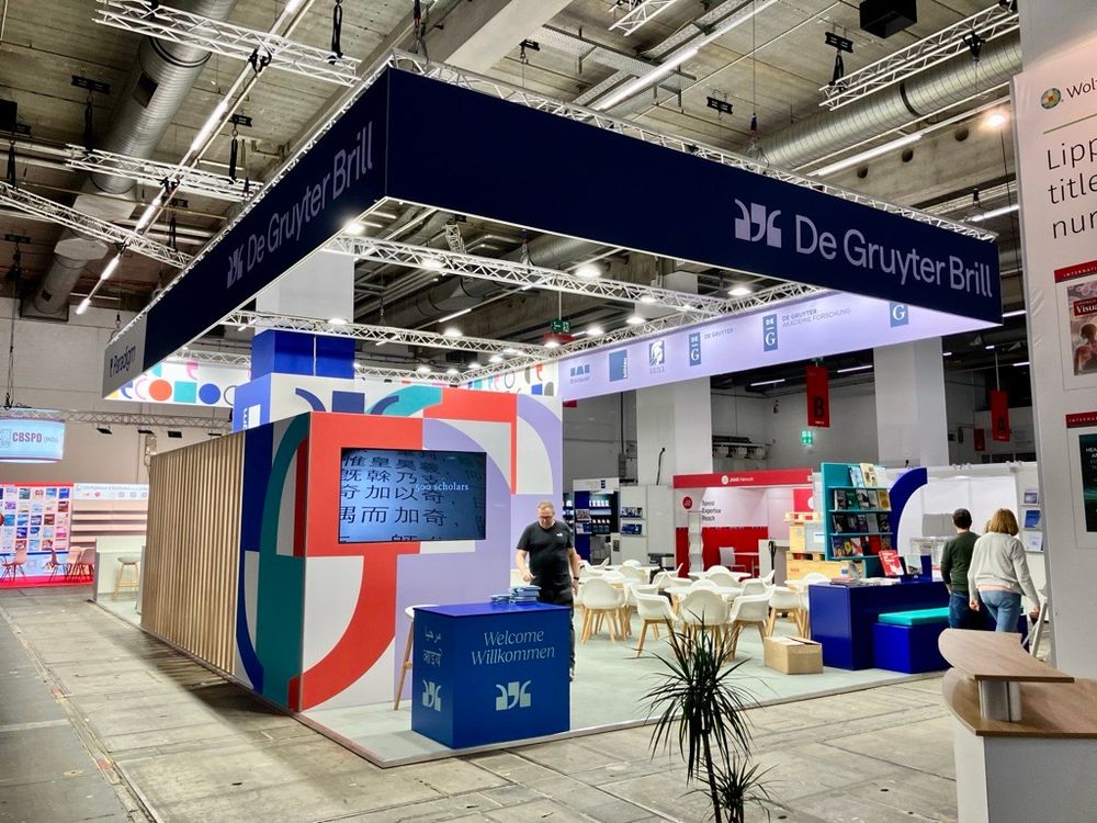 Photo of the colorful De Gruyter Brill stand during setup at the Frankfurt Book Fair